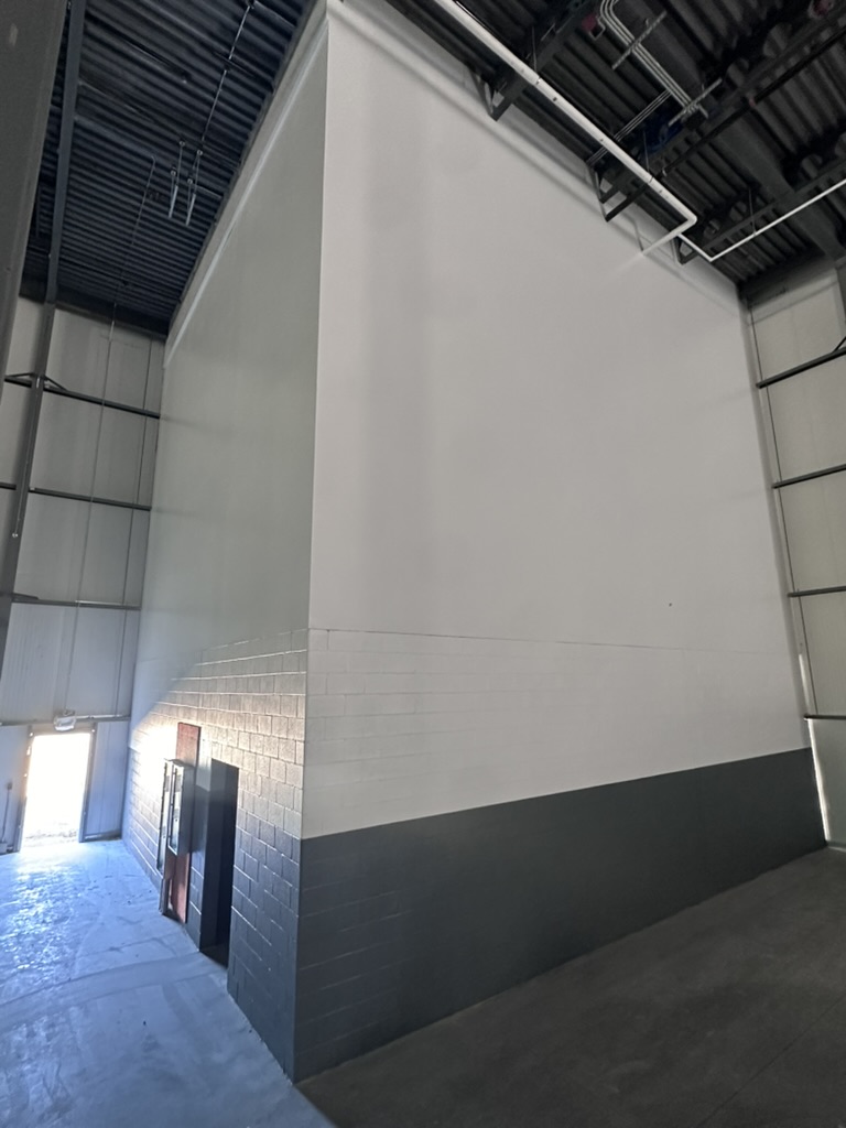 Painted two-tone walls in a large warehouse interior